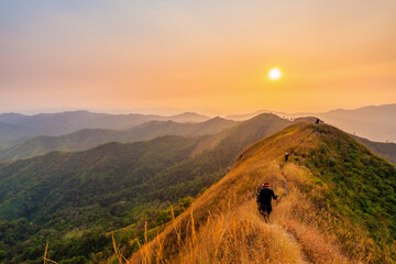 traveler man hiking enjoying in the mountains with backpack at Khao Chang Puak mountain Thailand © CasanoWa Stutio