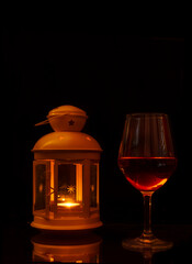 Glass of wine illuminated by a lantern