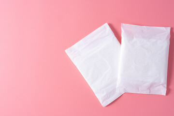 Sanitary pad, Sanitary napkin on pink background. Menstruation, Feminine hygiene, top view. © saran