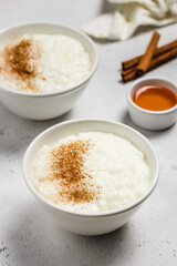 Cinnamon rice pudding in bowls. Space for text.