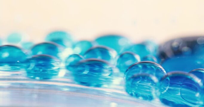 Blue Liquid Bubbles Sliding Down Surface