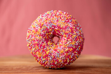 Pink donut on a pink background