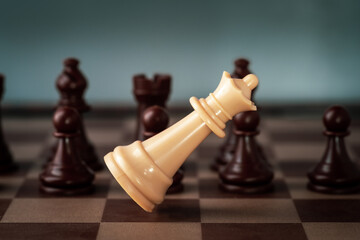 white chess queen  falling on chess board concept of failing.