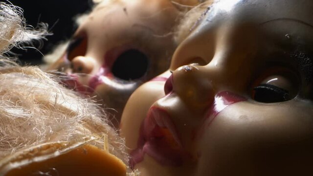 extremely close-up detailed. broken mutilated dolls. halloween concept.