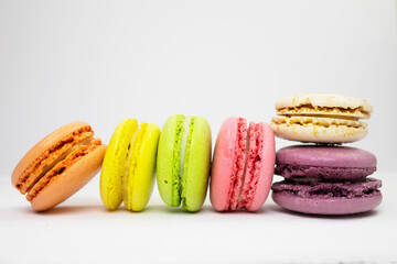 Colored macaroons close-up on a white background. Side view.