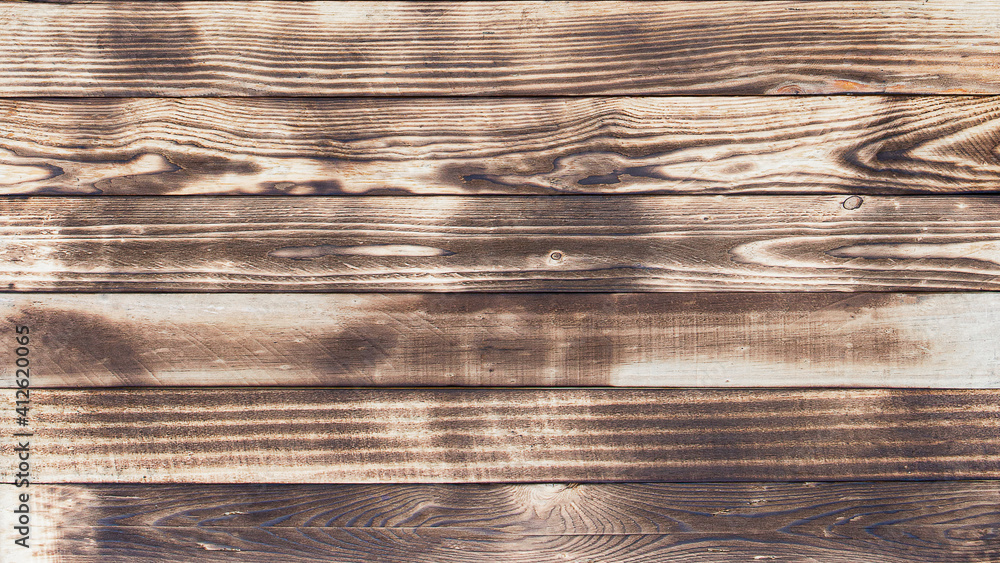 Poster Wooden floor with traces of being burnt makes a black abstract background and texture.