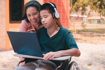 Special need child on wheelchair use a tablet in the house with his parent, Study or Work at home...