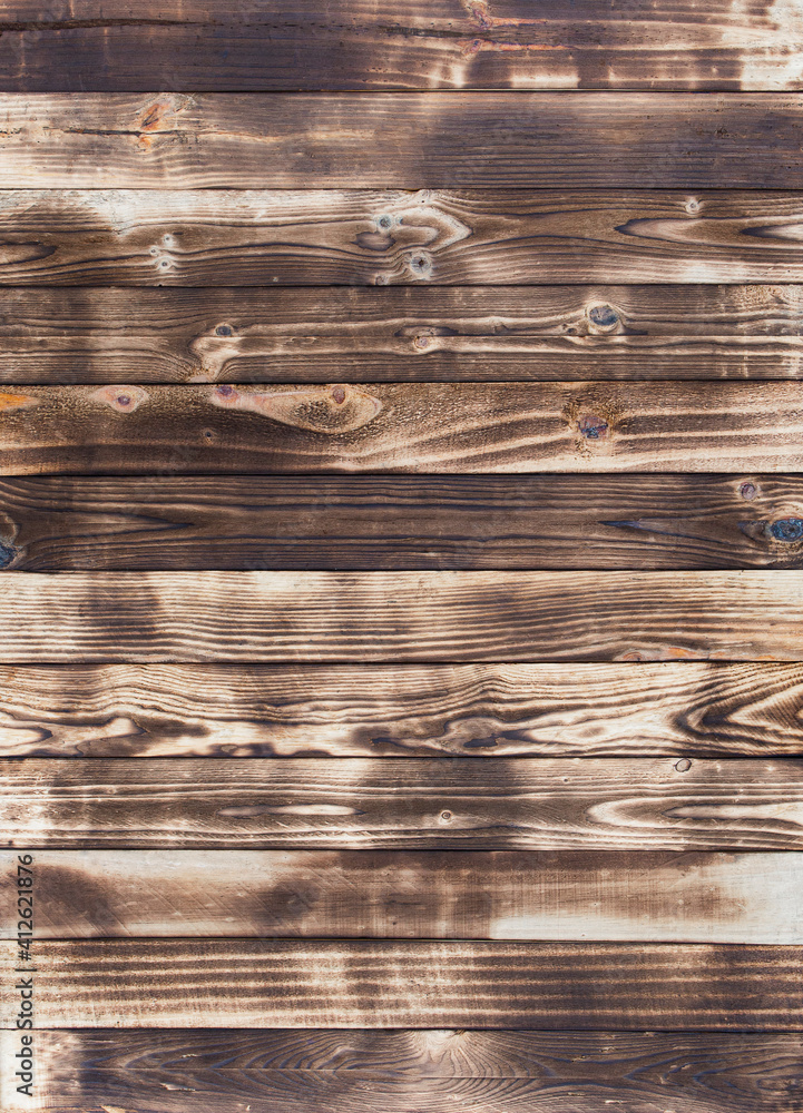 Poster wooden floor with traces of being burnt makes a black abstract background and texture.
