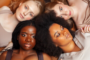 Obraz premium young pretty caucasian, afro, scandinavian woman posing cheerful together on brown background, lifestyle diverse nationality people concept