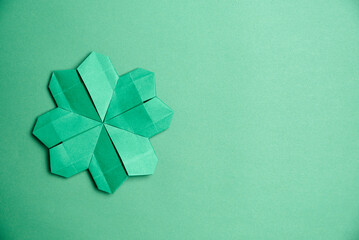 St. Patrick's Day card: four-leaf paper clover on green background