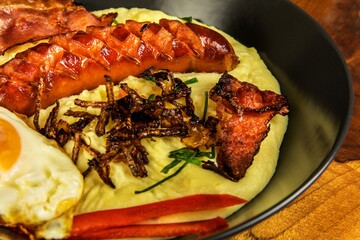 Pork sausages with mashed potato. Bangers and mash pork sausages and mashed potato. Unhealthy and greasy food. Grilled sausage.