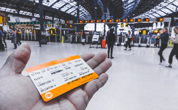 Brighton, England-18 October,2018: Hand holding a UK train ticket at Brighton & Hove train station for background in Brighton, England.