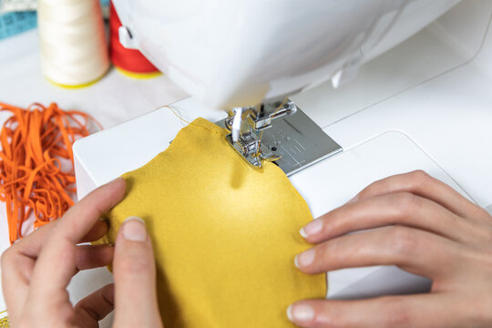 Sewing fabric masks on the sewing machine. Make your own face mask at home. 