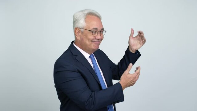 Middle age businessman extending hands to the side and inviting to come over isolated background