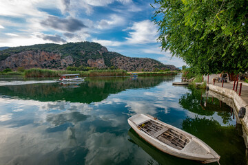 Fototapeta premium June13, 2020. Dalyan, Mugla - Turkey. Boats view at slope of Lycians rock tombs in Dalyan Town.