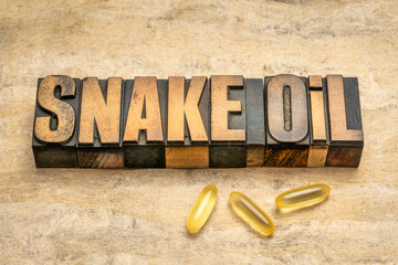 snake oil word abstract in vintage letterpress wood type, Chinese medicine or any method or product considered to be bogus or fraudulent