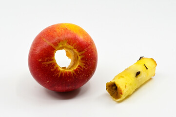 Close up of a cored apple with core alongside isolated against a plain white background. No people....