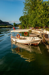 Obraz premium June13, 2020. Dalyan, Mugla - Turkey. Boats view at slope of Lycians rock tombs in Dalyan Town.