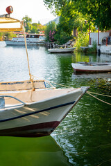 Obraz premium June13, 2020. Dalyan, Mugla - Turkey. Boats view at slope of Lycians rock tombs in Dalyan Town.