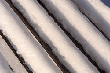 Fototapeta premium Snow covered park bench.