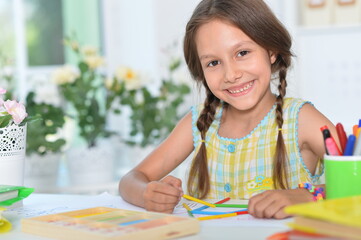 Cute girl learning to count with sticks at room