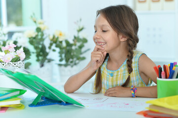 Cute little girl studying  at home