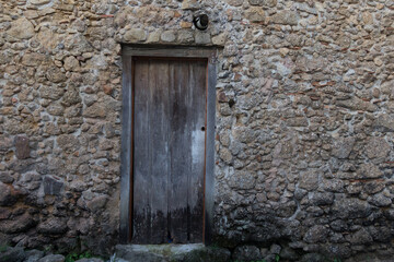 old wooden door in stone wall