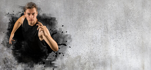 Sporty young man running on wall background. Sports banner