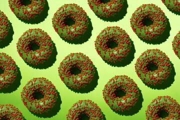 Green donuts with red crumb on a green background