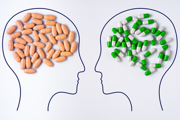 Heads of two people with nutritional supplements brain shape and pills brain shape. Two people with...