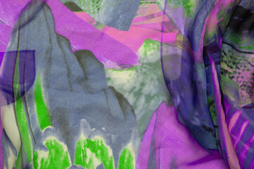 Silk fabric texture. Closeup of a beautifully folded multicolored silk scarf or headscarf with a pattern.