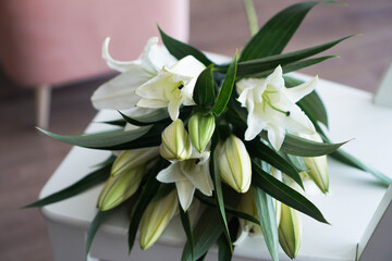 Lily bouquet on the background of modern white-pink interior