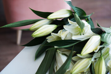 Lily bouquet on the background of modern white-pink interior