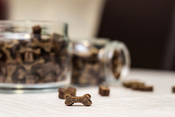 Dog treats spilling out of bowl. Dog treats and biscuits