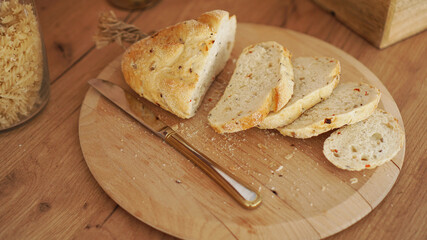 Sliced white bread on a wooden tray. Modern Scandinavian style kitchen.