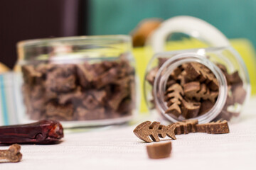 Dog treats spilling out of bowl. Dog treats and biscuits
