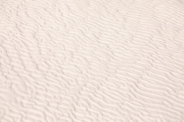 White sand ripples texture. Desert, beach, ripple shape on sandy surface.