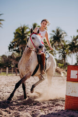 little girl running barrels on horse back 