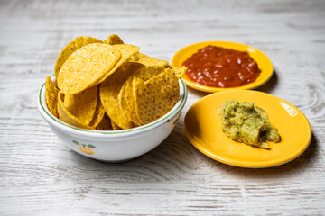 Guacamole sauce nachos and pepper sauce