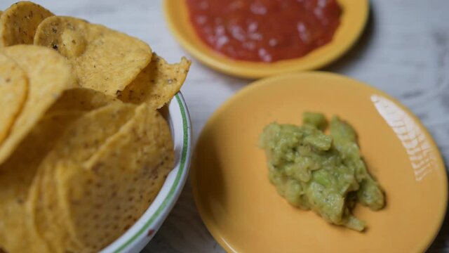 Guacamole sauce nachos and pepper sauce