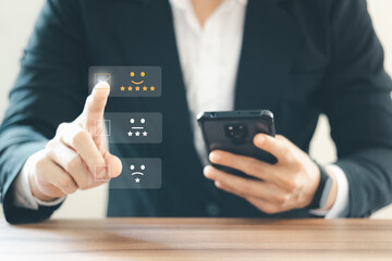 Businessmen are choosing screen on the happy Smiley face icon to give satisfaction in service,...