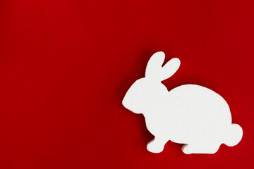 Easter rabbit silhouette isolated on a red background.