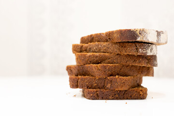 Sliced black bread on a white table in the kitchen
