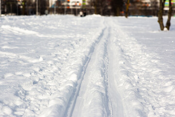 Fototapeta na wymiar well-worn ski track in the city park