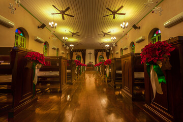 Beautiful interior view of little country church with empty wooden pews.