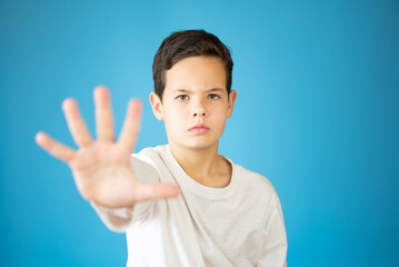 cool young boy showing number five isolated on blue background