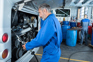 Fototapeta na wymiar car mechanic at the garage checking a car