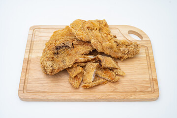 Top view of fried chicken and cutlet (also call fried chicken chop) on wooden chopping board. Malaysian night market food. Isolated on white background.
