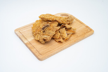 Top view of fried chicken and cutlet (also call fried chicken chop) on wooden chopping board. Malaysian night market food. Isolated on white background.