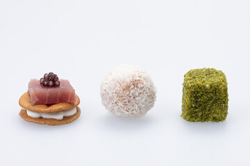 Canape with tuna and two mini cheese balls on white